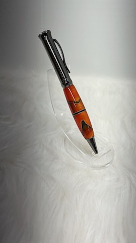 Here we have a PKM-4 Gun Metal Ballpoint Twist Pen with Orange with black and silver swirl ribbon and a center segmenting spacer.