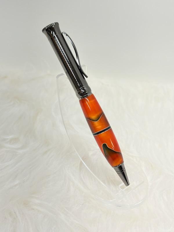 Here we have a PKM-4 Gun Metal Ballpoint Twist Pen with Orange with black and silver swirl ribbon and a center segmenting spacer.