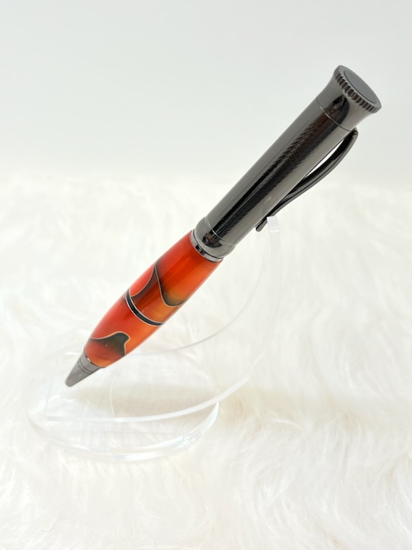 Here we have a PKM-4 Gun Metal Ballpoint Twist Pen with Orange with black and silver swirl ribbon and a center segmenting spacer.