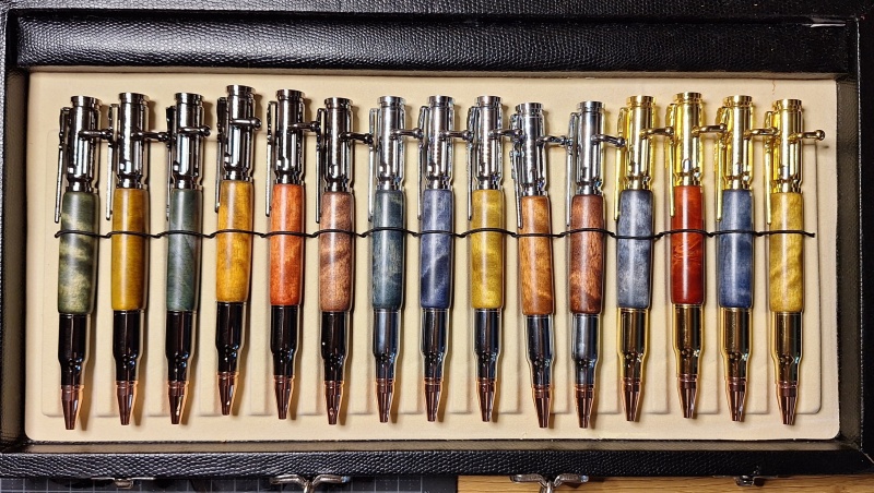Set of bolt action pen kits, with colored birch-burl mid-pieces