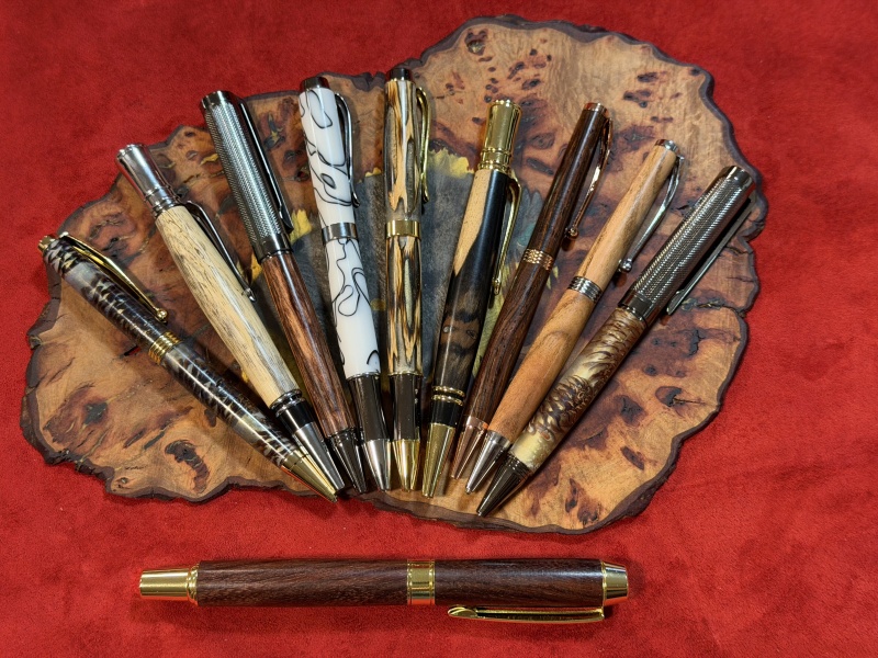 Various pen kits finished in resin and pine cones or cholla cactus, acrylic, and exotic woods.